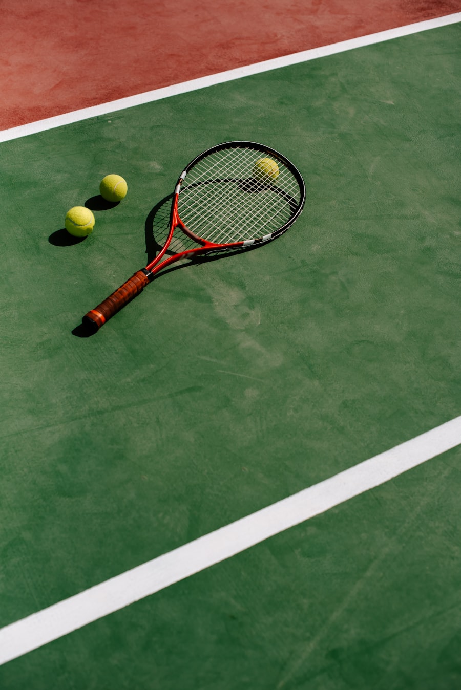 A tennis racket and balls on a court